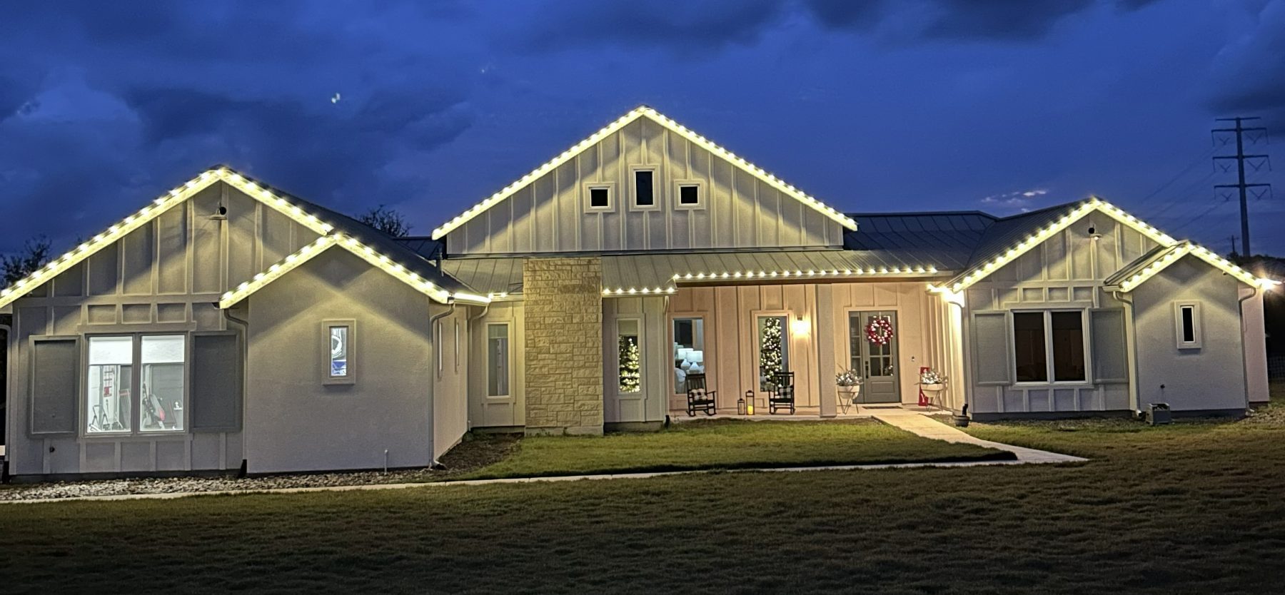 Farmhouse with every gable and eave outlined in warm white C9 bulbs